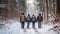 Group of friends with backpacks walking in snowy forest. Back view