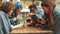 Group of friends in blankets sit outside the cafe and pour tea in cups