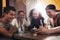 Group of friends in a cafe looking at mobile phone