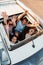 group of friends in car looking up through sunroof