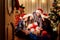 In a group of friends in christmas hats on the floor in the room