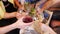 Group of friends are clink glasses with drinks at cafe. Close-up