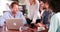 Group Of Friends In Coffee Shop Using Digital Devices