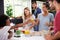 Group Of Friends Cooking Breakfast In Kitchen Together