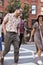 Group Of Friends Crossing Urban Street In New York City