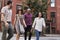 Group Of Friends Crossing Urban Street In New York City