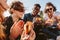 Group of friends eating burger on mountain top