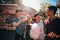 Group of friends eating candyfloss at fairground