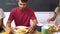 Group Of Friends Eating Cooked Breakfast In Kitchen Together