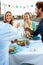 Group Of Friends Eating Meal On Rooftop Terrace