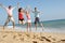 Group Of Friends Enjoying Beach Holiday In The Sun