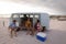 Group of friends enjoying at beach while standing near camper van