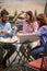 Group of friends enjoying a coffee and a talk in the bar`s yard. Friendship, together, outside, bar