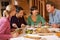 Group Of Friends Enjoying Meal In Alpine Chalet