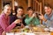 Group Of Friends Enjoying Meal In Alpine Chalet