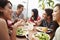 Group Of Friends Enjoying Meal At Rooftop Restaurant