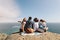 Group of friends enjoying view from top of a hill