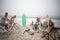 Group of friends having picnic on the beach