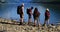 Group of friends hiking near riverside 4k