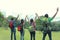 Group of friends on a hiking raise their hand together