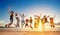 Group of friends jumping on beach