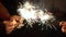 A group of friends lit sparklers together. People get ready for the holiday and light Bengal fires. The company of