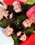 Group of friends lying on grass looking up