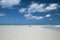 A group of friends lying on the sand at low tide