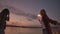 A group of friends of men and women merry celebrate the holiday on the beach with sparklers and fireworks. Slow motion