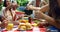 Group of friends passing the plate of meal at outdoors barbecue party