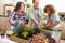 Group Of Friends Planting Rooftop Garden Together