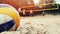 Group of friends playing beach volleyball closeup of ball in sand