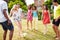 Group Of Friends Playing Football In Garden