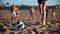 A group of friends plays beach volleyball, a slender brunette girl runs after the ball