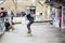 A group of friends practise skateboarding at a skate park on the South Bank of the river Thames, London