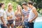 Group of friends preparing barbecue near pool