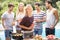 Group of friends preparing for outdoors barbecue party