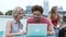 Group Of Friends Relaxing Together On Rooftop Terrace