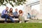 Group Of Friends Relaxing By Tower Bridge In London