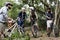 Group of friends ride mountain bike in the forest together