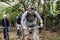 Group of friends ride mountain bike in the forest together