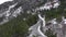 Group of friends riding bicycles on mountain switchbacks. Cyclists cycling road bikes through snowy mountain hills. Cycling sport