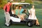 Group Of Friends Riding In Golf Buggy