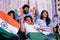 Group of friends shouting India India while watching sports match on television at home - Concept of group of people supporting