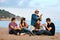 Group of friends singing on beach.