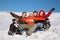 Group of friends sit on plastic sled