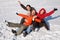 Group of friends sit on plastic sled