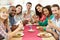 Group Of Friends Sitting Around Table Having Dinner Party