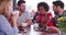 Group Of Friends Sitting In Coffee Shop Chatting