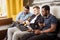 Group of friends sitting on sofa with laptop